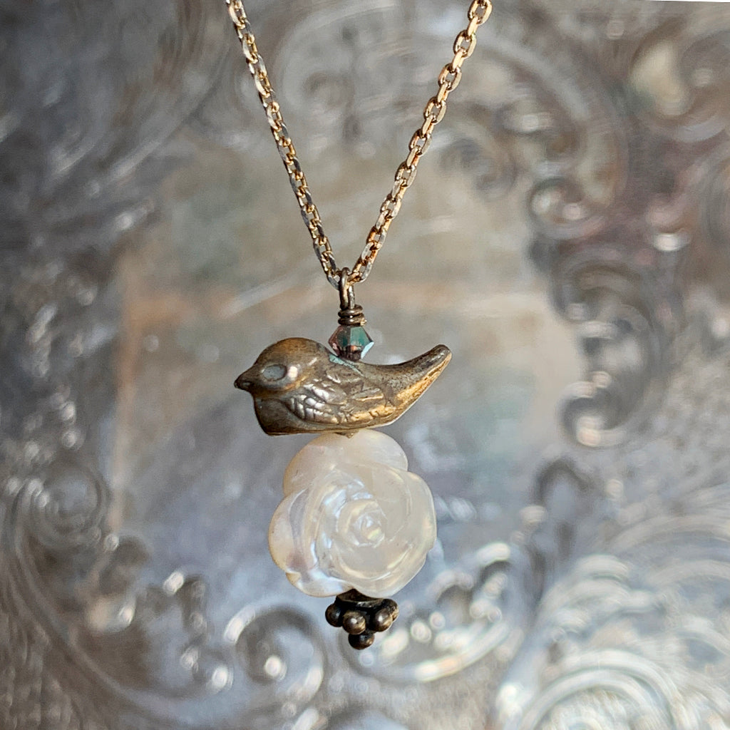 Solid Silver Bird on a Mother of Pearl Carved Rose on a Silver Necklace