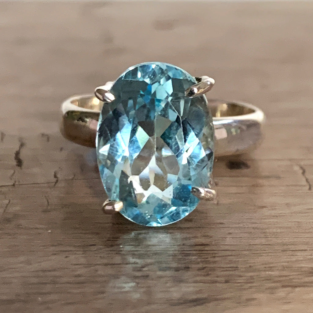 Oval Blue Topaz in Clawset Silver Ring